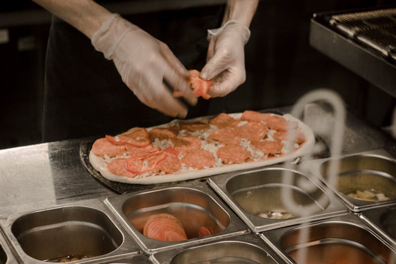 Imos Pizza kitchen with fresh ingredients and pizza making process